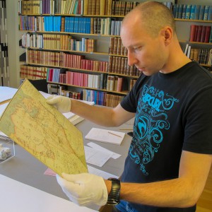 Lars studying an old map showing Armfeldts military campaign in Norway.
